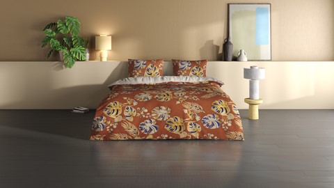een bed met beddengoed en kussens
