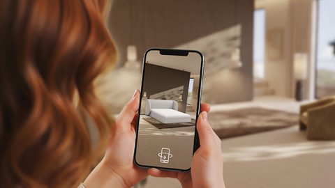 Iemand die een telefoon vasthoudt met een foto van een slaapkamer