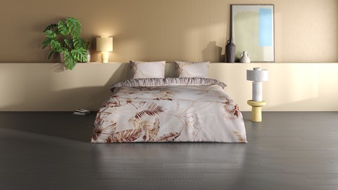 een bed met kussens en een plant ervoor