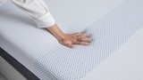 de hand van een persoon op een matras
