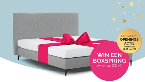 een bed met een roze strik