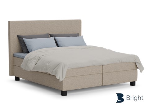 Een bed met een wit dekbed