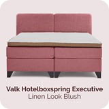 Een roze bed met een matras