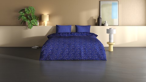 een bed met blauw dekbed en kussens