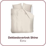 Een bed met een witte deken en kussens